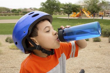 Thirsty Boy Drinking Water Outdoors