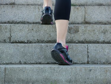 Young sport woman walking upstairs in gym shoes