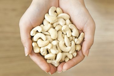 Cashew nuts in woman's hands