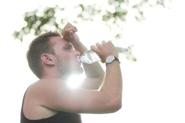 male runner drinking mineral water