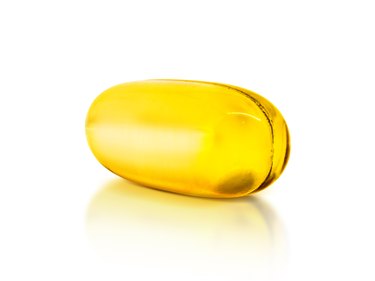 Fish oil supplement capsule isolated on white background