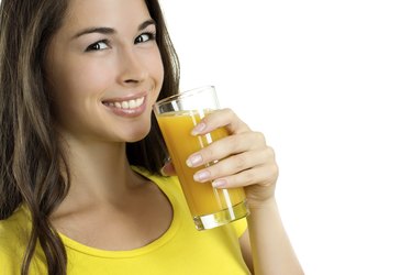 Beautiful woman drinking orange juice