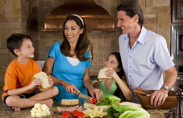 Attractive Family In Kitchen Making Healthy Sandwiches