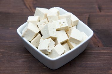 Cubes of tofu square bowl on wood