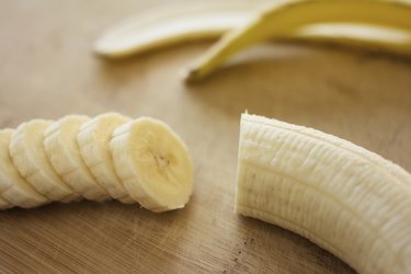 Sliced organic bananas on wooden background to support a K normal range