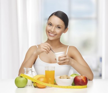 woman with healthy breakfast and measuring tape