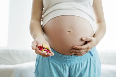 Pregnant woman with pills