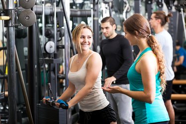 Active people having weightlifting training