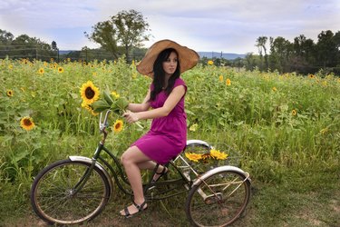 Woman on bike with sunflowers