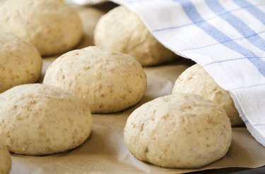 Oat bread buns on a baking sheet