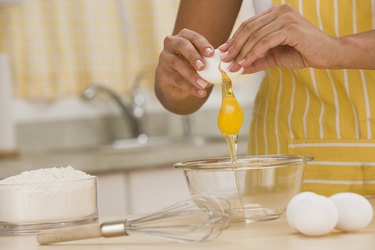 Woman breaking egg into bowl