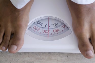 Extreme close-up of person's feet on scales