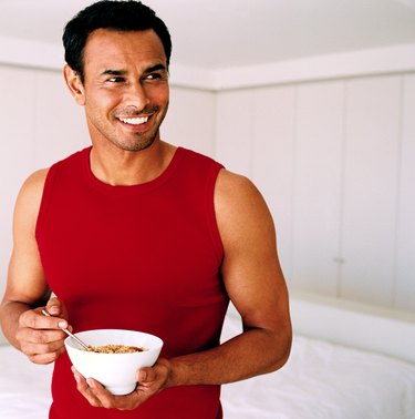 Young man holding a bowl of cereal