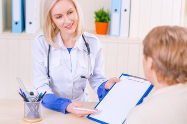 Pleasant nurse speaking with her patient