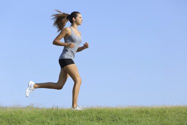 Beautiful woman runningwith the sky in background