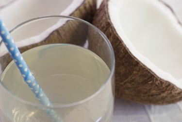 coconut water with straw and split coconut