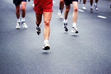 Marathon runners on road, low section 