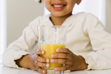 Girl with glass of orange juice