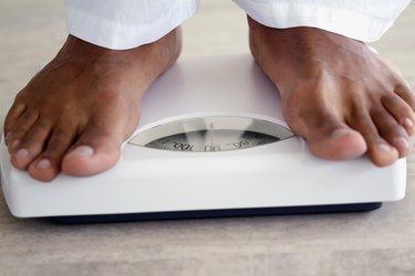 Close-up of a man standing on a scale