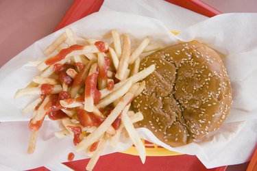 Hamburger and french fries on a fast food tray