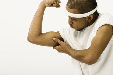 Studio shot of African man flexing biceps