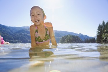 Asian girl standing in lake