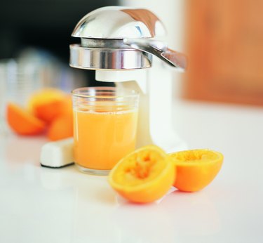 Juicer With a Glass of Fresh Orange Juice