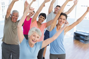 Portrait of smiling people doing power fitness exercise