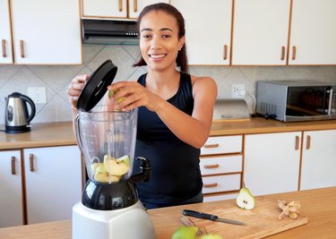 woman preparing fruit smoothie