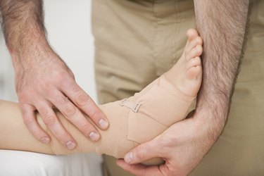 Foot being strapped by a doctor