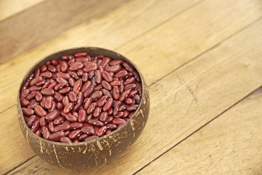 Kidney beans over wooden board background
