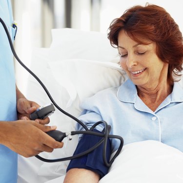 an elderly woman getting her blood pressure checked