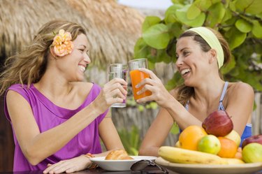 Women talking and having tropical fruit