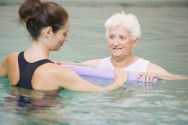 Instructor And Elderly Patient Undergoing Water Therapy