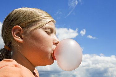 girl blowing a bubble gum