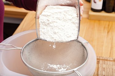 Put flour of glass bowl through a sieve