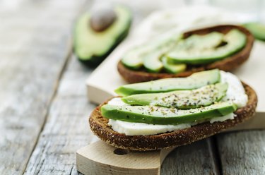 sandwich of rye bread with avocado and goat cheese