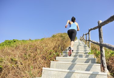 woman running up on mountain stairs