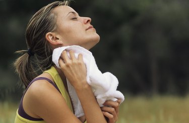 Jogger wiping face with towel, Murcia, Spain