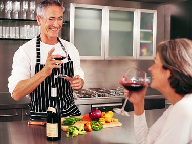 Mature Couple Drinking Wine in Their Kitchen