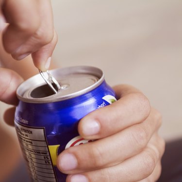Extreme close-up of woman opening canned drink