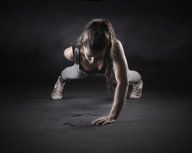 Black and white image of a woman doing pushups