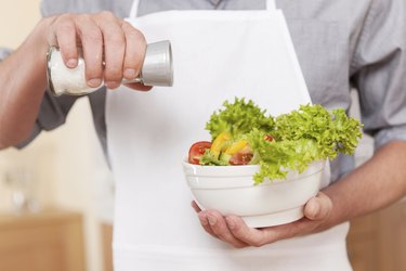 Salting salad.