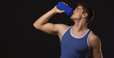 Muscular man drinking protein shake