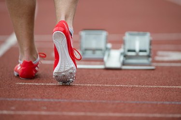 Professional sprinter walking towards starting line on running track