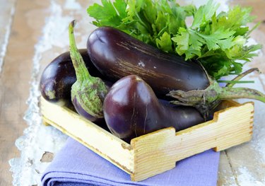 fresh ripe organic eggplants on a wooden table