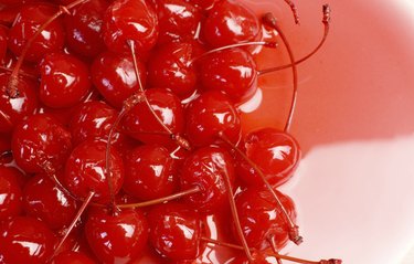 Close up of red cocktail maraschino cherries with stems