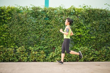 Asian woman running in the park healthy