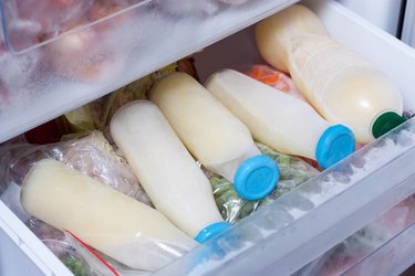 Milk in glass bottle in the refrigerator