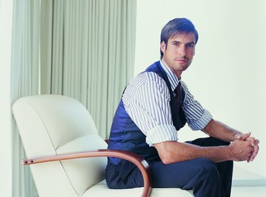 Portrait of a Stylish Businessman Sitting in an Armchair